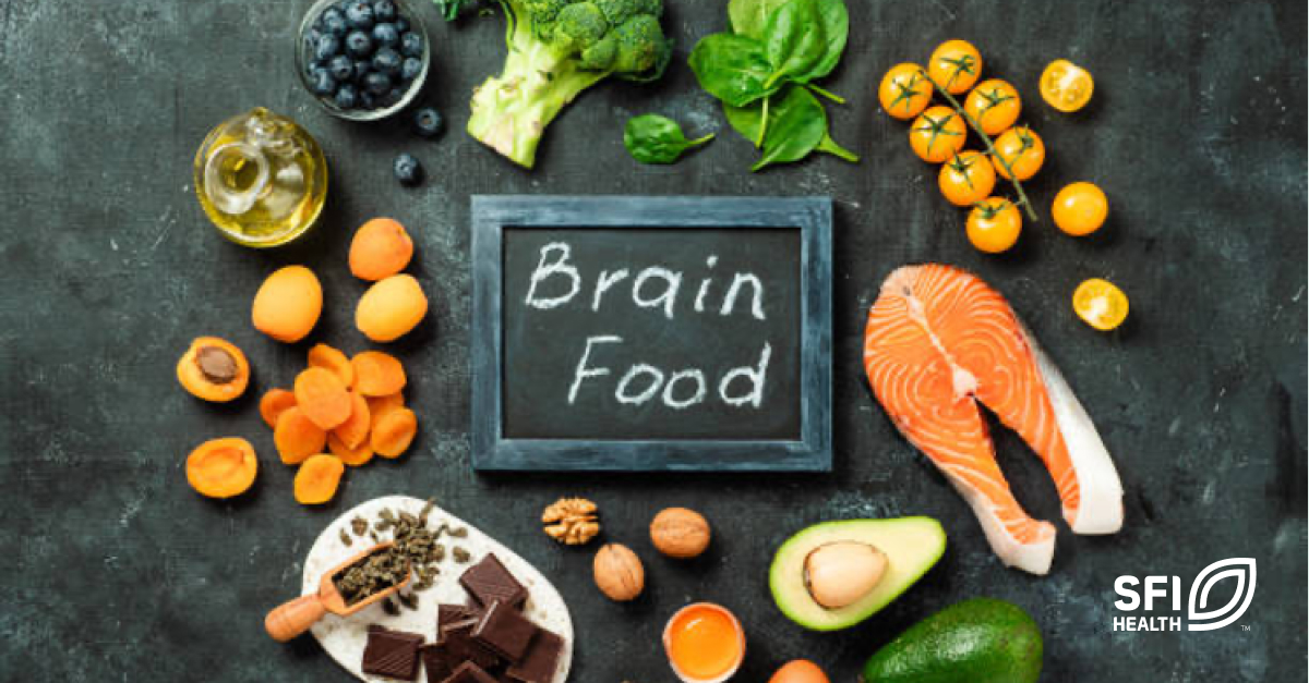 Healthy brain foods like salmon, chocolate and avocado on a table